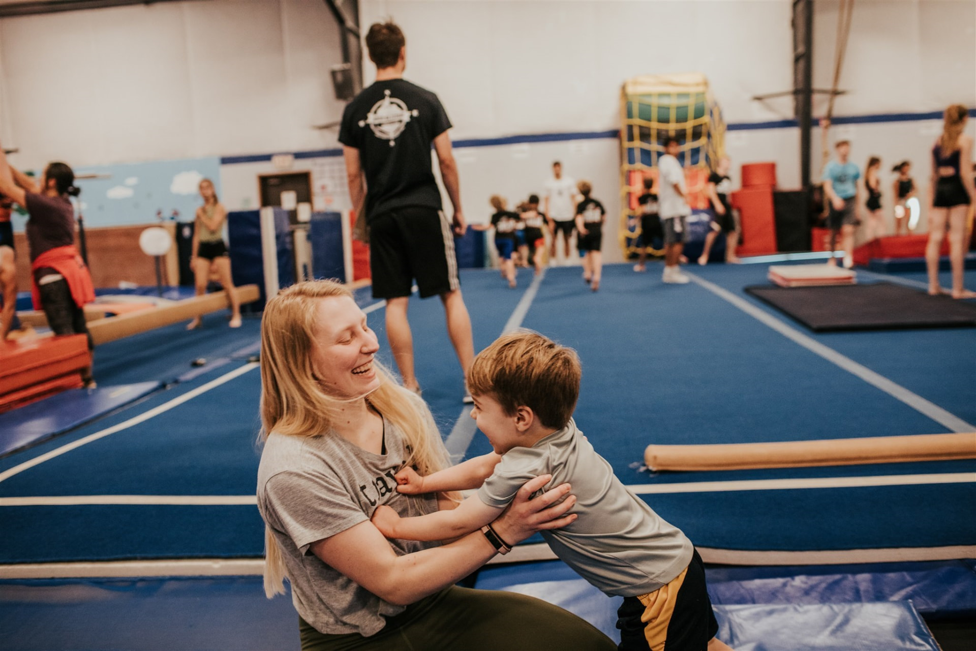 Coach helping a young gymnast at North Coast