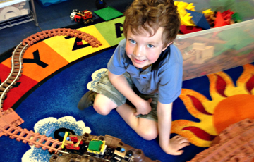 Pre-K student playing with classroom toys