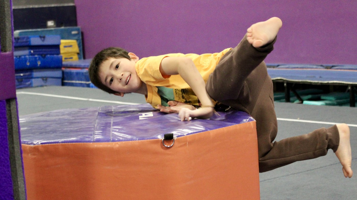 Boy climbing over a foam block