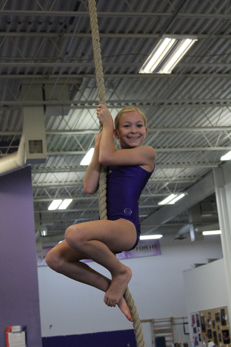 Gymnast climbing a rope