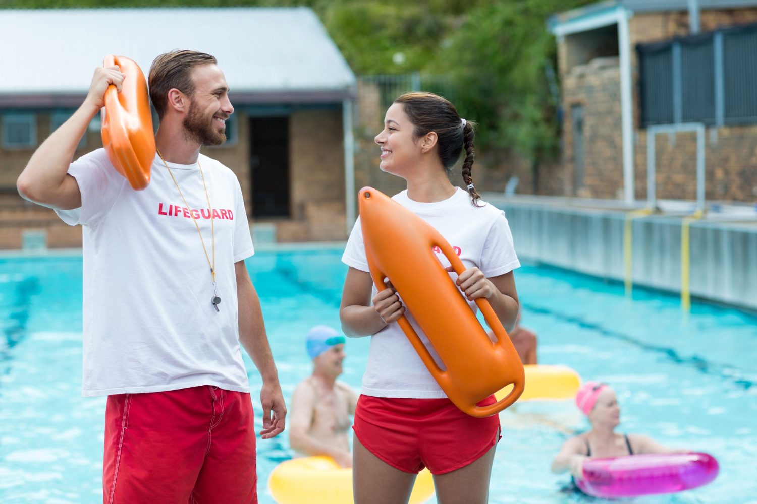 Smiling certified lifeguard on duty at a Southern California pool