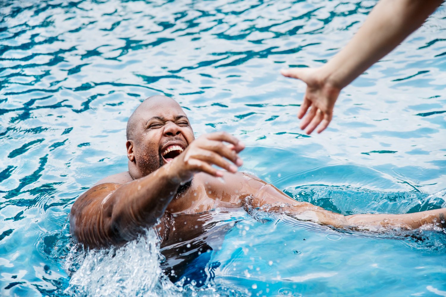 Lifeguard practising an in-water rescue hold with a swimmer