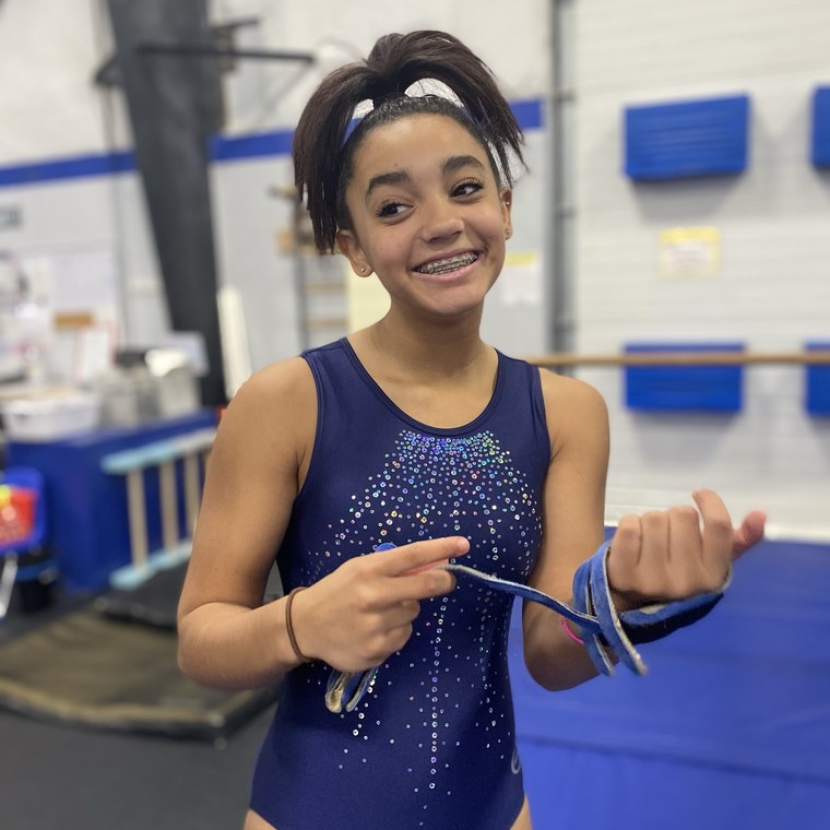 A team gymnast smiling in the gym