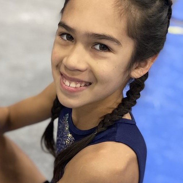A gymnast chalking up before her set